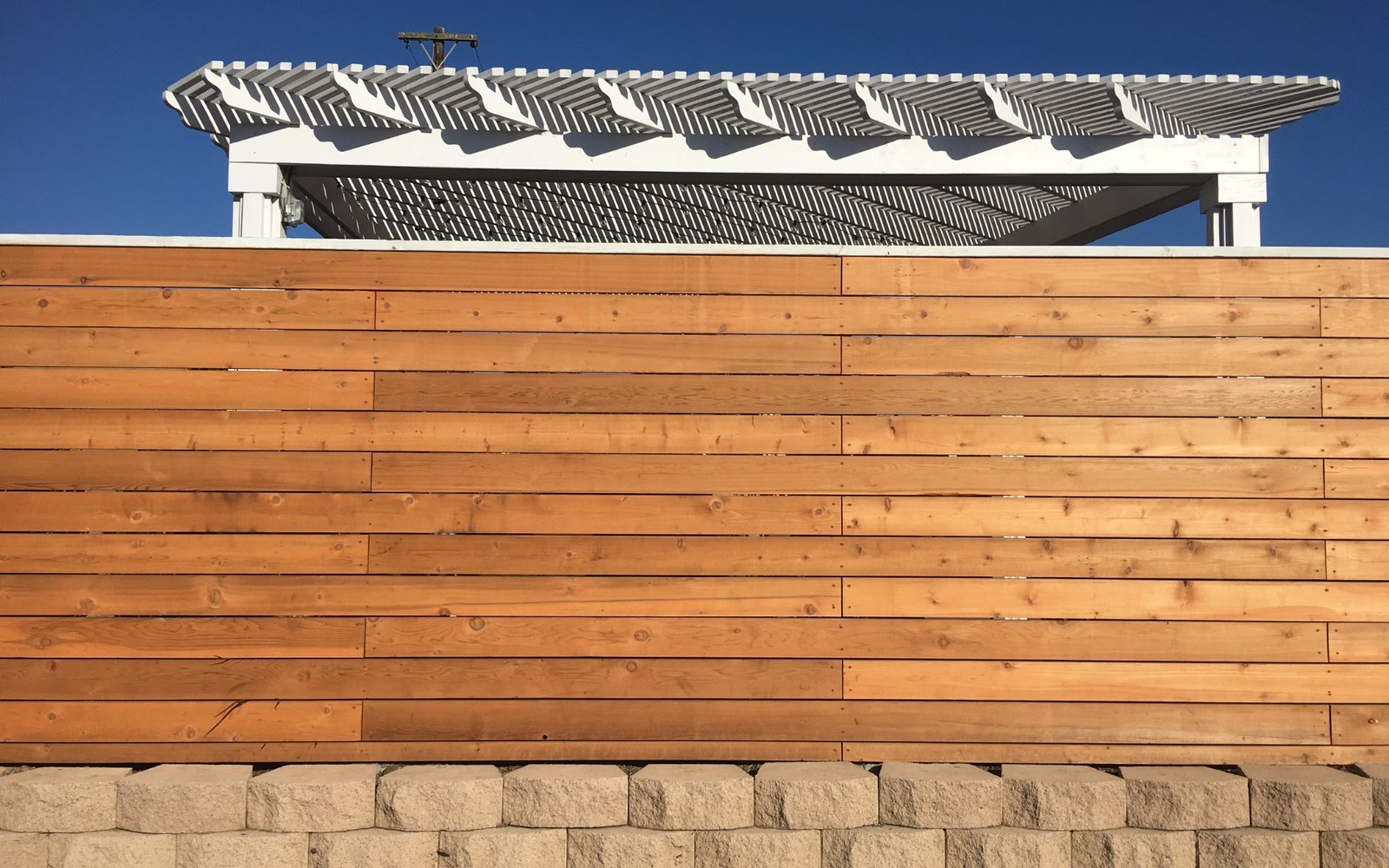 Horizontal Wood Fence and Planter Wall Stone